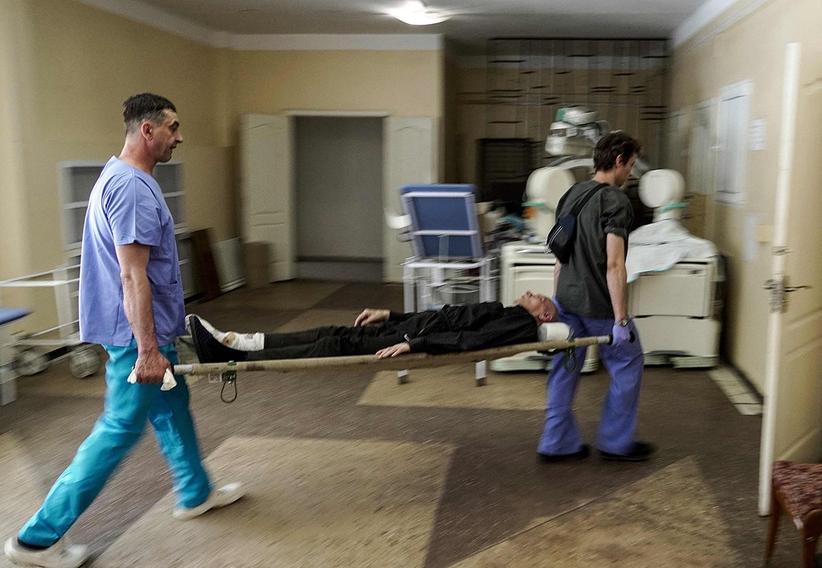 Медики несут мужчину на носилках в больницу Мариуполя 3 июня 2022 года. Фото: AFP / Scanpix / LETA